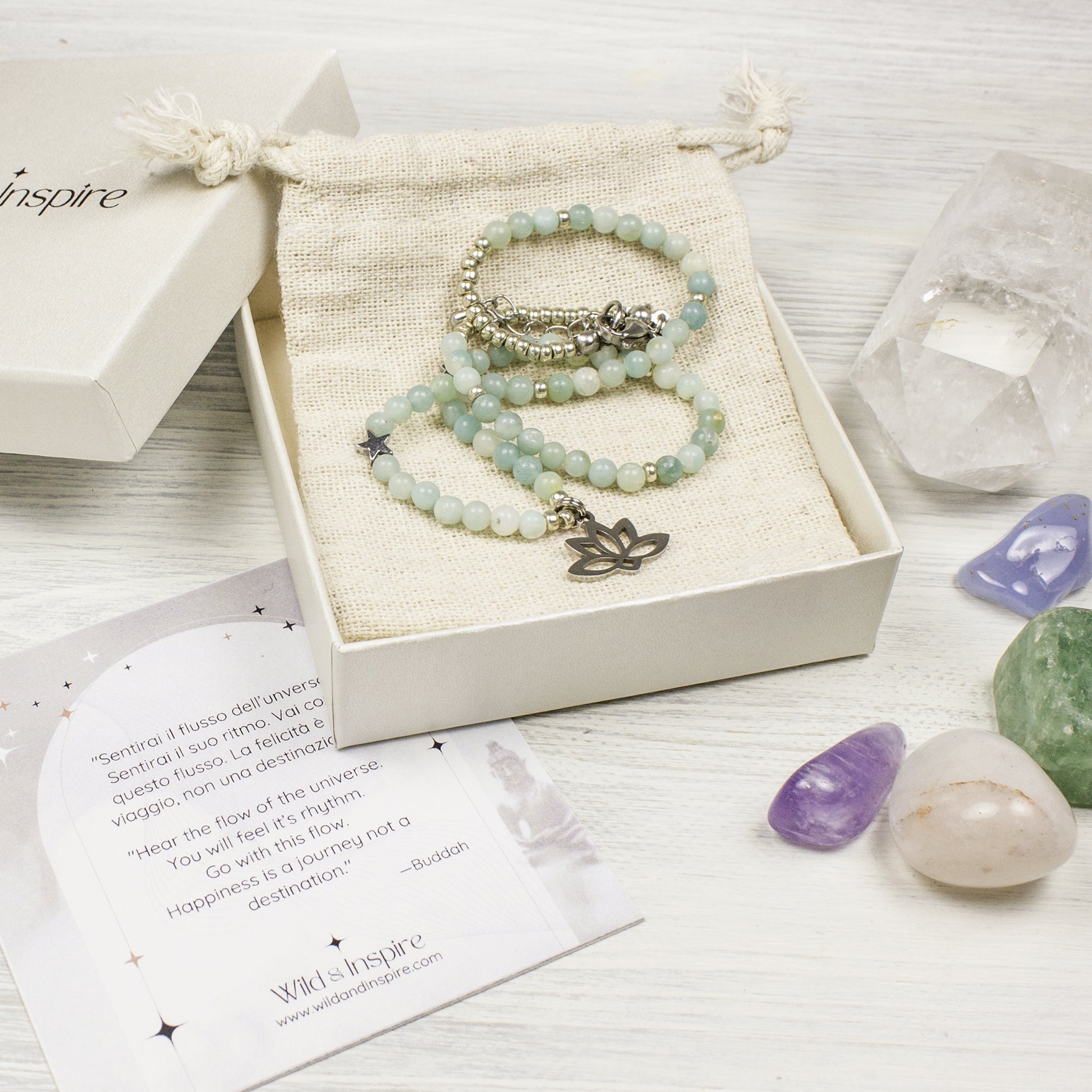 beaded necklace in a gift box with crystals and an affirmation card on a wooden surface