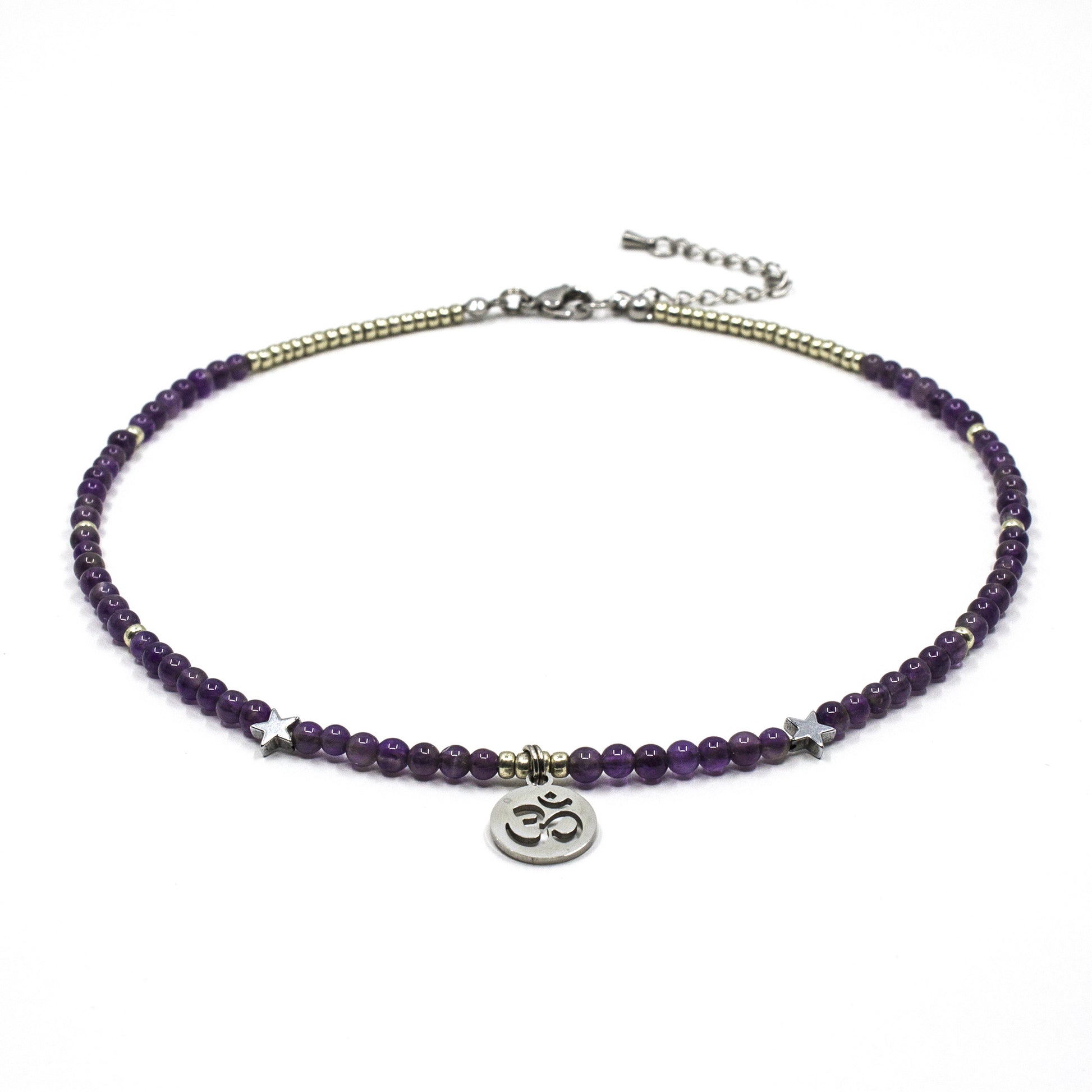 Purple beaded necklace with a silver Om symbol charm on a white background