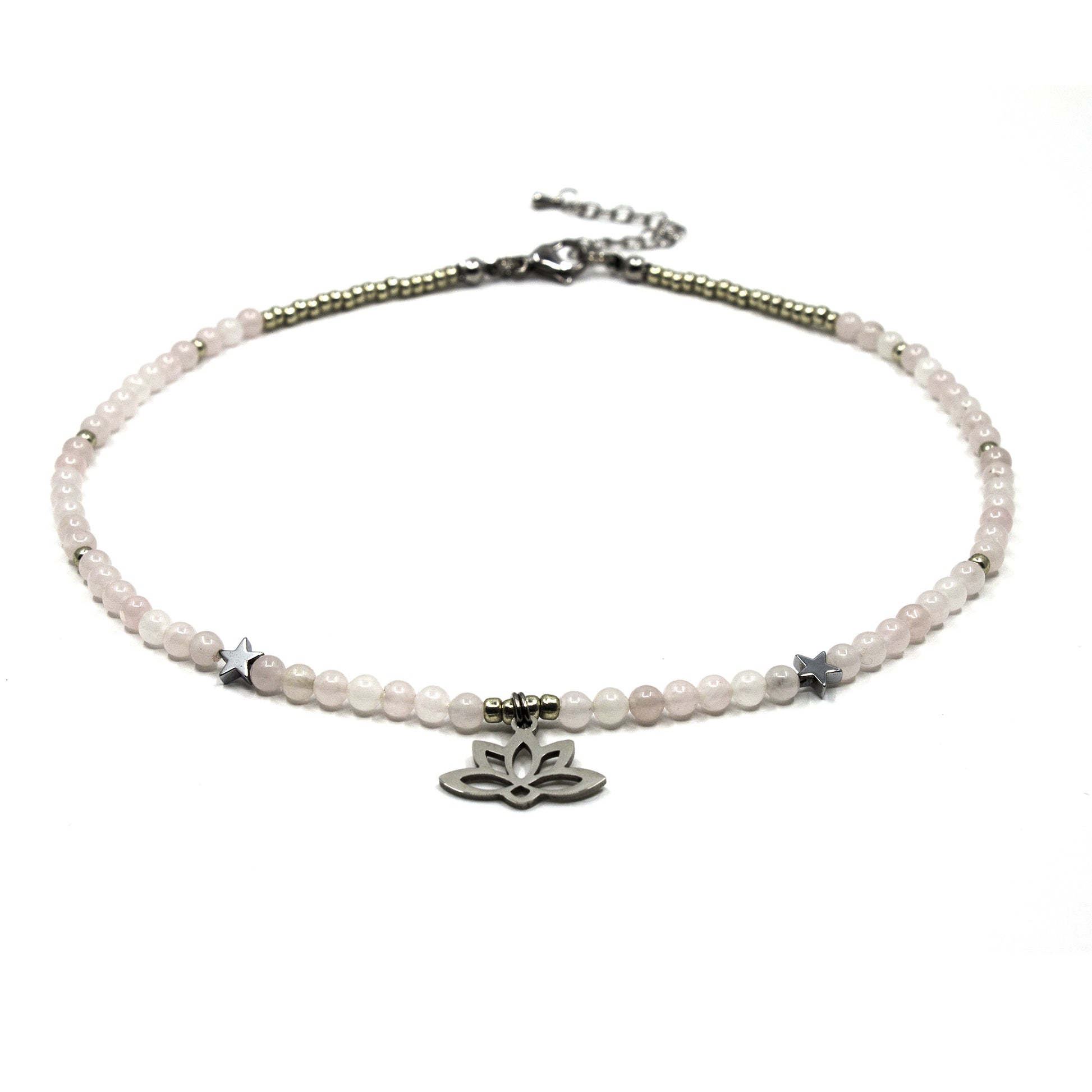 Delicate beaded  necklace with a lotus flower charm on a white background