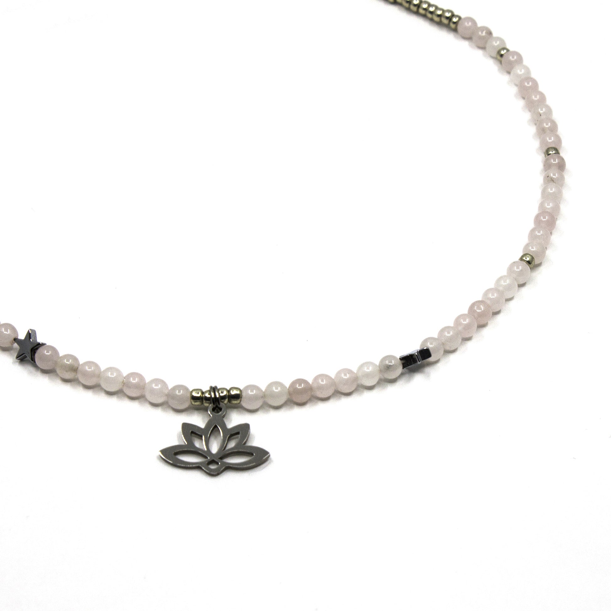 Necklace with pink rose quartz beads and a silver lotus flower charm on a white background