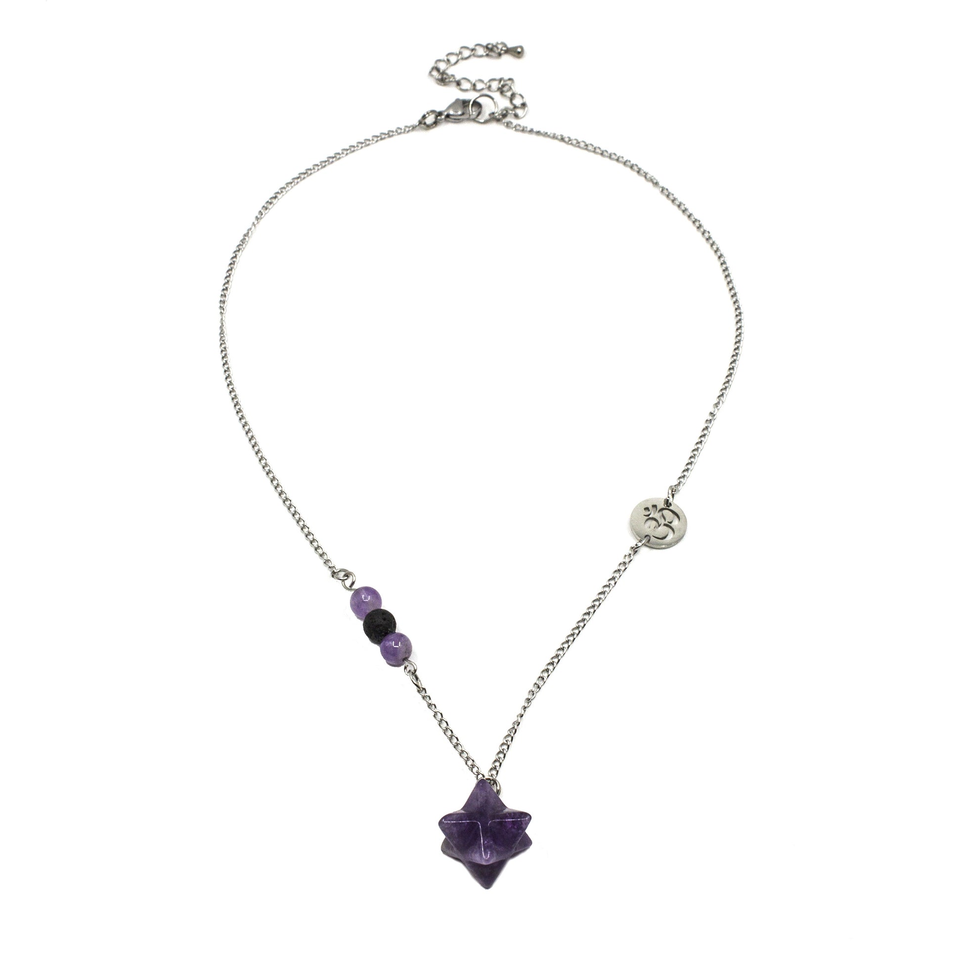 Silver chain necklace wth a spiritual gemstone pendant and om charm on a white background